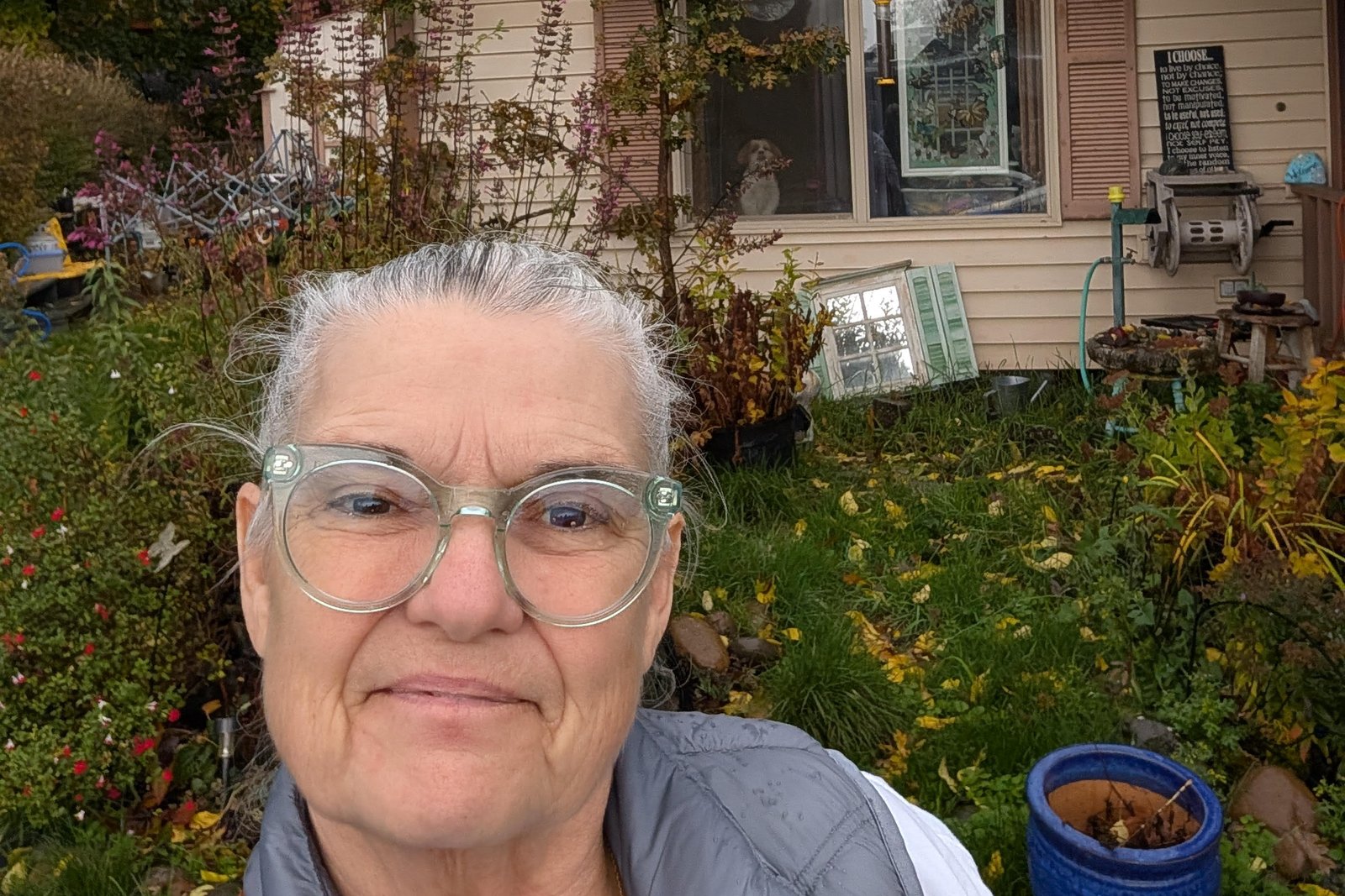 A homeowner in her garden in front of her newly installed solar panels