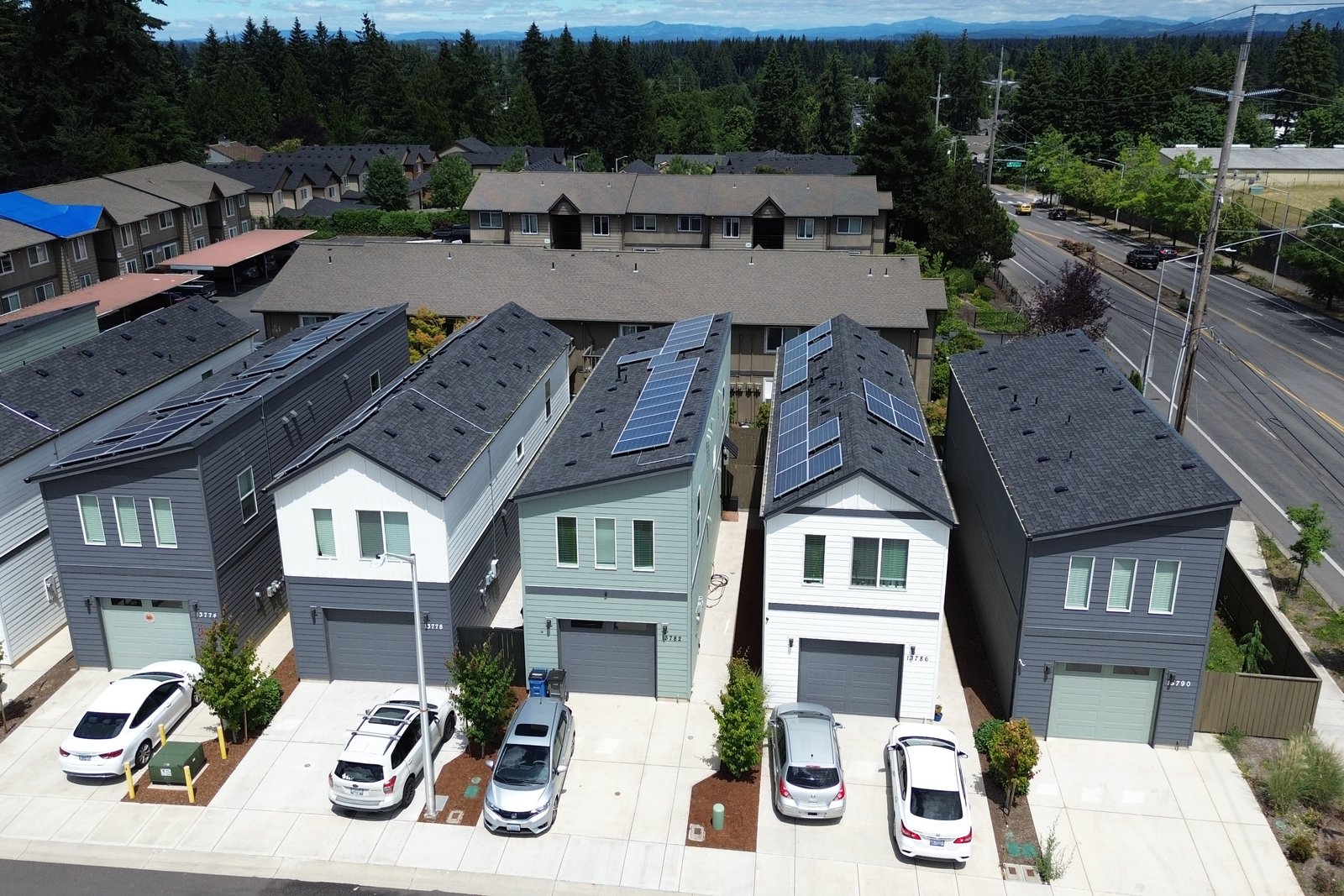 Aerial view of the NE 20th Circle homes with solar panels, mountains beyond
